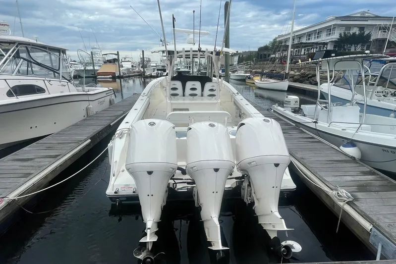 Pier Pressure Yacht Photos Pics 2018 Cobia 344 Center Console boat docked with triple outboard engines.