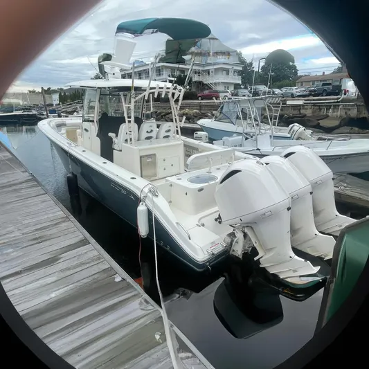 Pier Pressure Yacht Photos Pics 2018 Cobia 344 Center Console boat docked with triple outboard engines.
