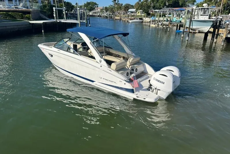  Yacht Photos Pics 2019 Regal 29 OBX boat with Yamaha engines on a calm waterway.