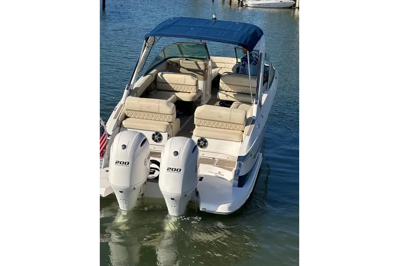  Yacht Photos Pics 2019 Regal 29 OBX boat with dual 200 horsepower engines, docked on calm water.