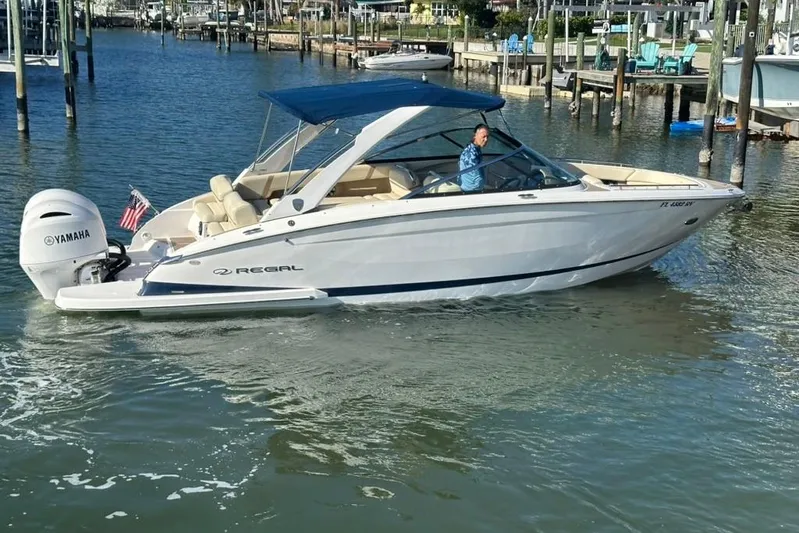  Yacht Photos Pics 2019 Regal 29 OBX boat with Yamaha engine cruising in a marina.