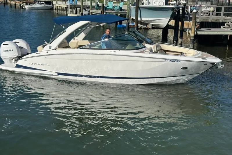  Yacht Photos Pics 2019 Regal 29 OBX boat with Yamaha engines on a calm waterway.