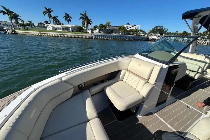  Yacht Photos Pics 2019 Regal 29 OBX boat with luxurious seating on a sunny waterfront.