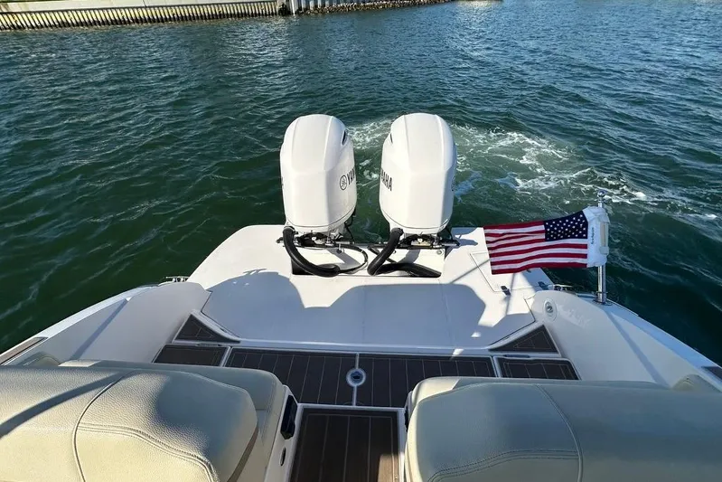 Yacht Photos Pics 2019 Regal 29 OBX boat with dual Yamaha engines and American flag on water.