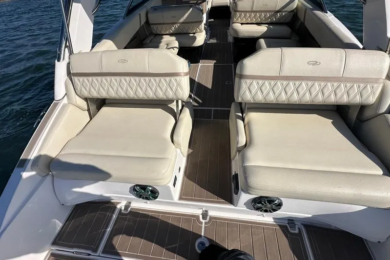  Yacht Photos Pics 2019 Regal 29 OBX boat interior with beige seating and wood flooring on the water.