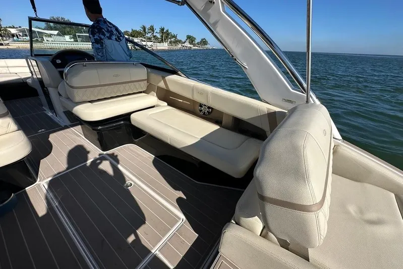  Yacht Photos Pics 2019 Regal 29 OBX boat interior with beige seating, on calm water.