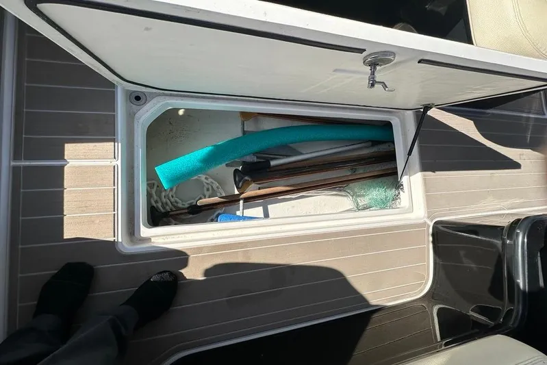  Yacht Photos Pics Open storage compartment on 2019 Regal 29 OBX boat with various items inside.