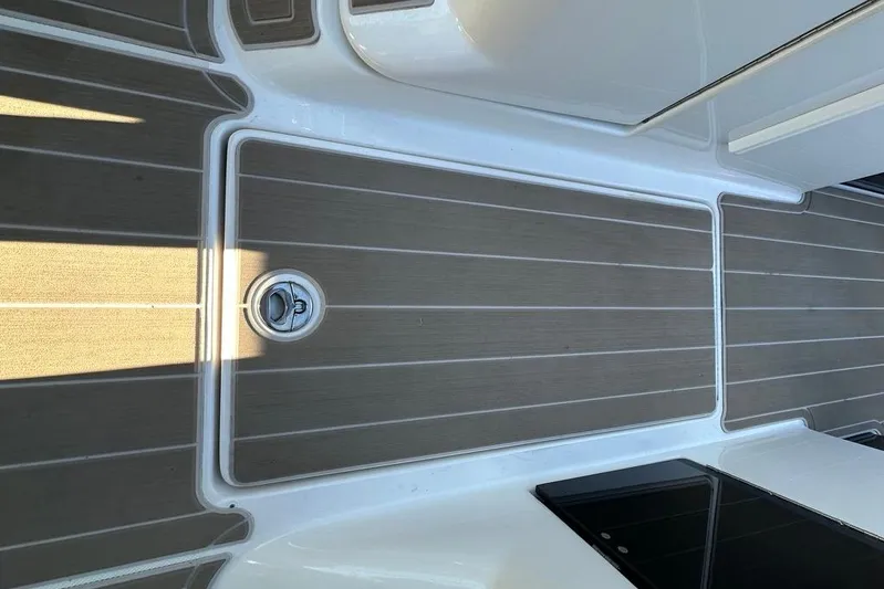  Yacht Photos Pics 2019 Regal 29 OBX boat deck with wood-like flooring and metal latch.