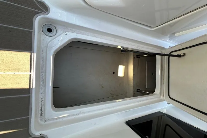  Yacht Photos Pics Open storage compartment on a 2019 Regal 29 OBX boat, showcasing interior space.