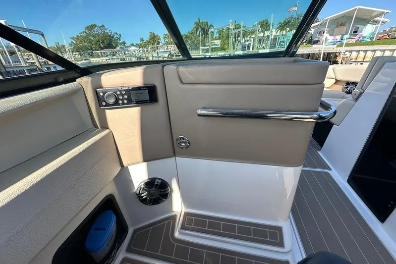  Yacht Photos Pics Interior view of a 2019 Regal 29 OBX boat, featuring a control panel and seating area.