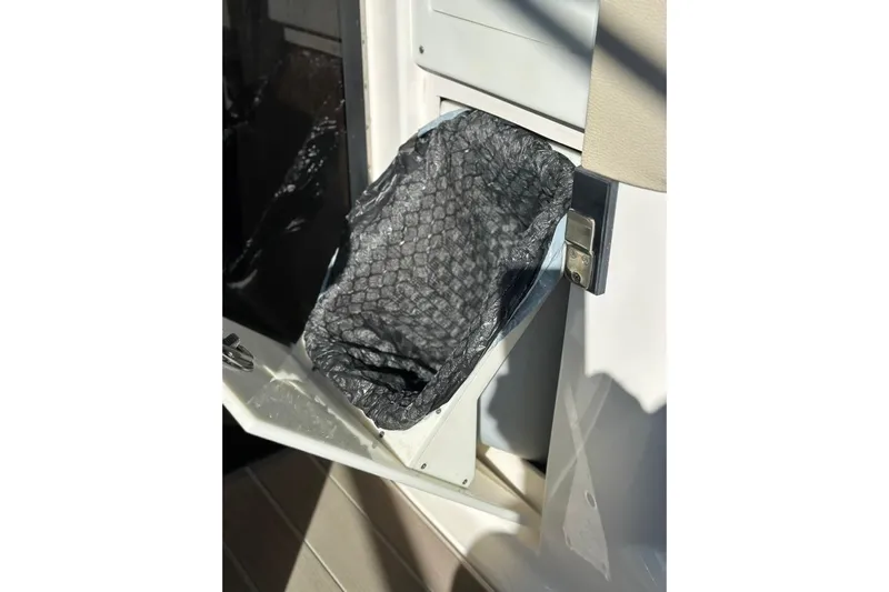  Yacht Photos Pics 2019 Regal 29 OBX boat trash compartment with open lid and liner.