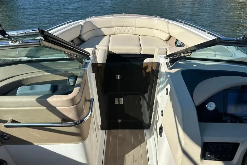  Yacht Photos Pics 2019 Regal 29 OBX boat interior with beige seating and open windshield.