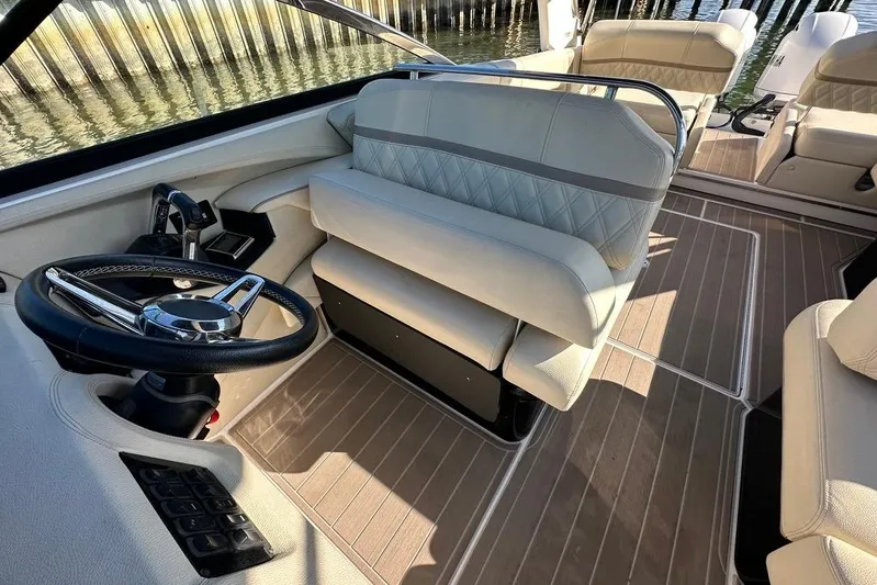  Yacht Photos Pics 2019 Regal 29 OBX boat interior with steering wheel and beige seating.