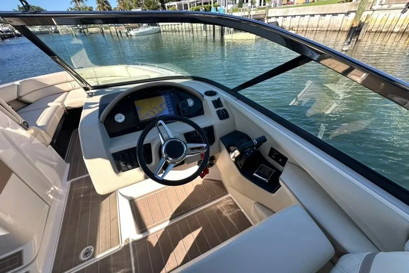  Yacht Photos Pics 2019 Regal 29 OBX boat cockpit with steering wheel and navigation system.