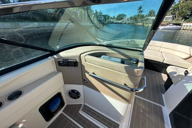  Yacht Photos Pics Interior view of 2019 Regal 29 OBX boat, featuring seating and control panel.