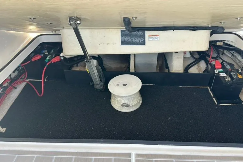  Yacht Photos Pics 2019 Regal 29 OBX boat storage compartment with battery and rope spool.