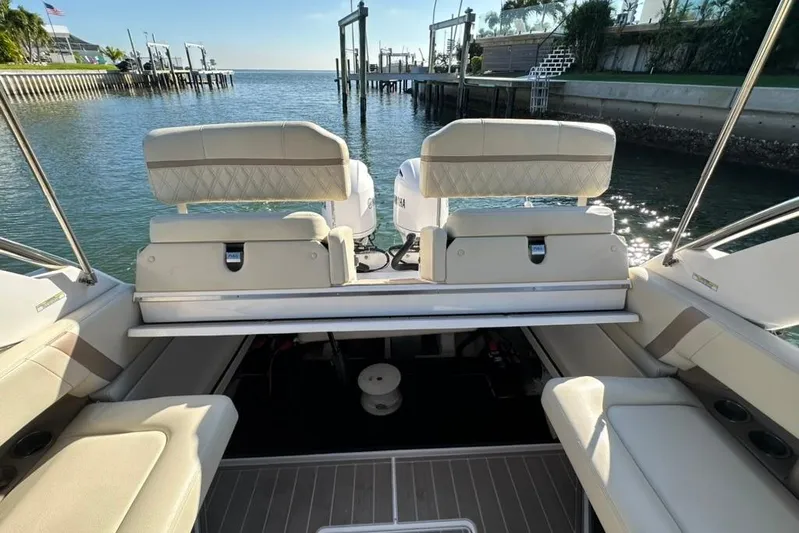  Yacht Photos Pics 2019 Regal 29 OBX boat interior with comfortable seating and scenic waterfront view.