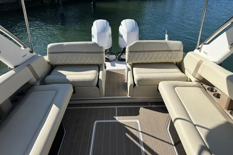  Yacht Photos Pics 2019 Regal 29 OBX boat interior with beige seating and twin outboard motors.