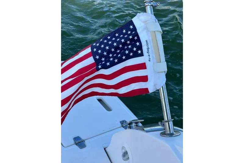  Yacht Photos Pics American flag on 2019 Regal 29 OBX boat, waving over water.