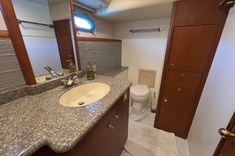 Tahoe Yacht Photos Pics Luxurious 1996 Queenship yacht bathroom with granite countertop and wooden cabinetry.