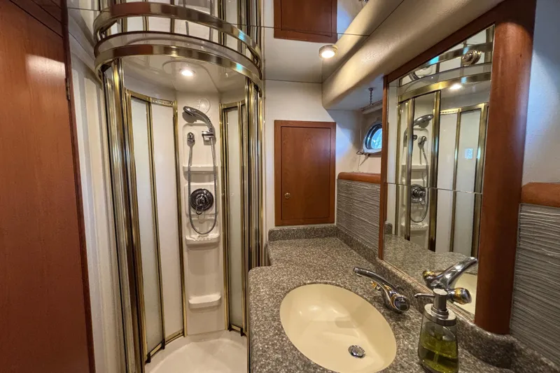 Tahoe Yacht Photos Pics Luxurious 1996 Queenship yacht bathroom with shower, sink, and elegant wood accents.
