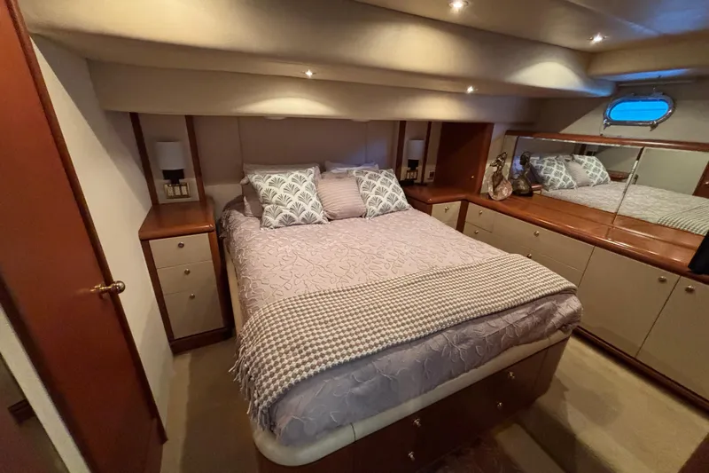 Tahoe Yacht Photos Pics Luxurious 1996 Queenship yacht bedroom with elegant bedding and wooden cabinetry.