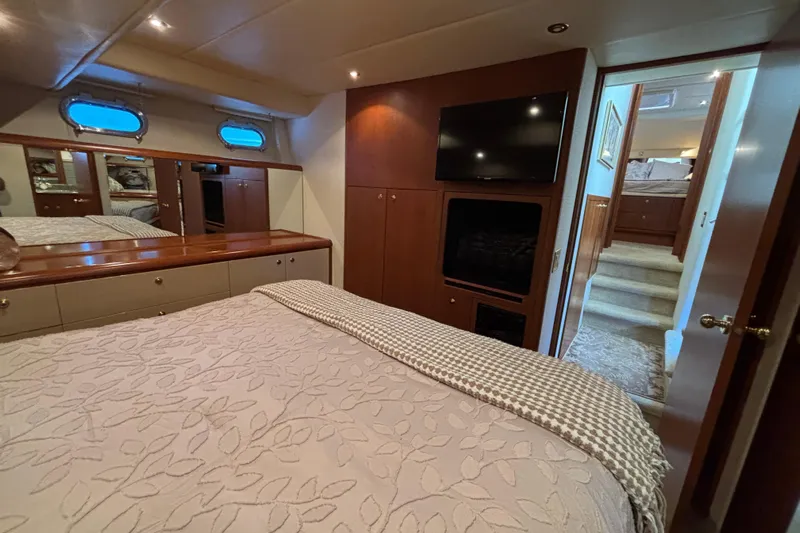 Tahoe Yacht Photos Pics Luxurious 1996 Queenship yacht bedroom with TV, elegant decor, and cozy bedding.