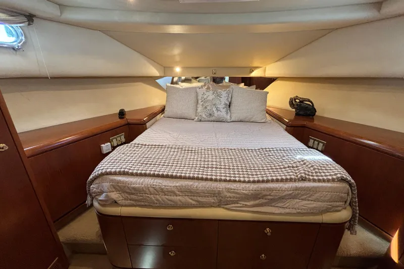 Tahoe Yacht Photos Pics Luxurious 1996 Queenship yacht bedroom with cozy bedding and elegant wood cabinetry.