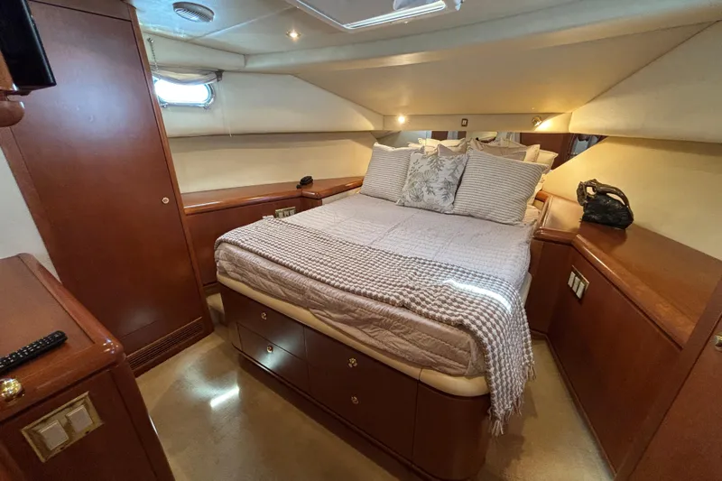 Tahoe Yacht Photos Pics Luxurious 1996 Queenship yacht bedroom with elegant wood furnishings and cozy bedding.