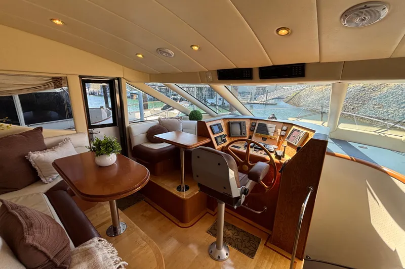 Tahoe Yacht Photos Pics Luxurious 1996 Queenship yacht interior with helm, plush seating, and elegant wood finishes.