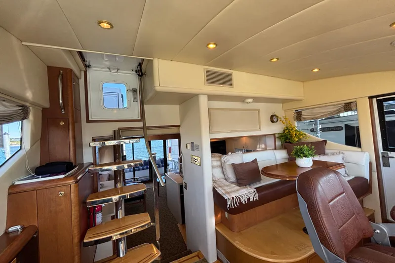 Tahoe Yacht Photos Pics Luxurious 1996 Queenship yacht interior with elegant seating and wooden accents.