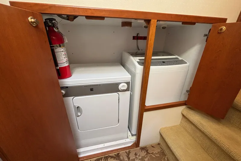 Tahoe Yacht Photos Pics Laundry area on a 1996 Queenship yacht with washer, dryer, and fire extinguisher.