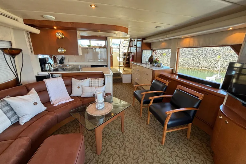 Tahoe Yacht Photos Pics Luxurious 1996 Queenship yacht interior with elegant seating, modern kitchen, and large windows.