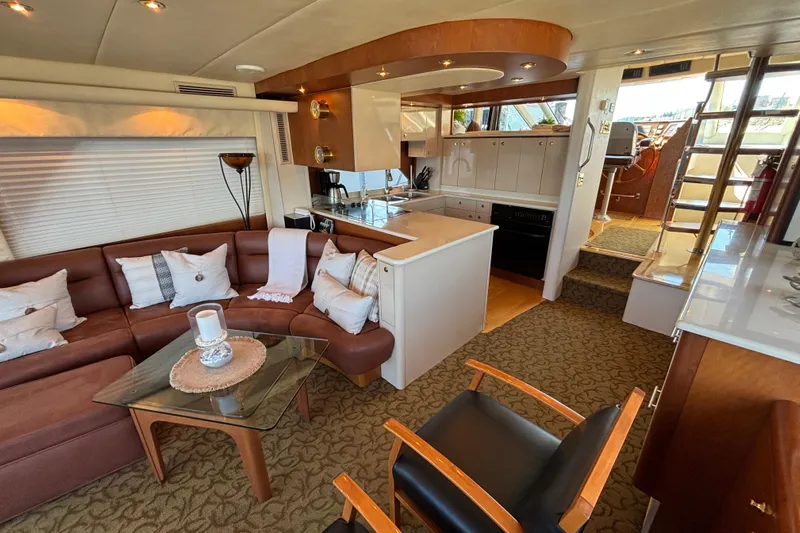 Tahoe Yacht Photos Pics Luxurious 1996 Queenship yacht interior with cozy seating, modern kitchen, and elegant decor.
