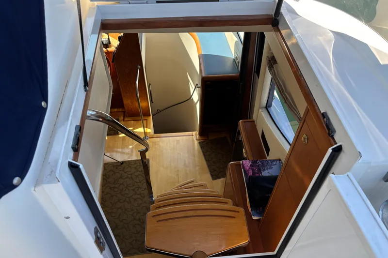 Tahoe Yacht Photos Pics Interior view of a 1996 Queenship yacht, featuring wooden stairs and elegant design.