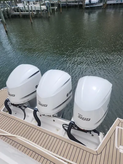 Dilligaf Yacht Photos Pics 2020 Regal 38 XO boat with triple 300 horsepower outboard engines docked at marina.