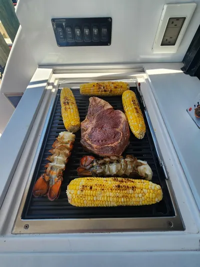 Dilligaf Yacht Photos Pics Grilled steak, lobster tails, and corn on a Regal 38 XO yacht's outdoor grill.