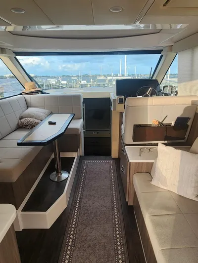 Dilligaf Yacht Photos Pics Interior of 2020 Regal 38 XO yacht with elegant seating and panoramic windows.
