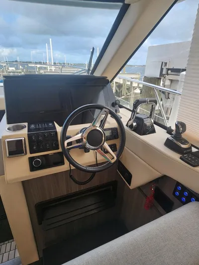 Dilligaf Yacht Photos Pics 2020 Regal 38 XO yacht helm with steering wheel and control panel.