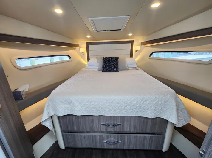 Dilligaf Yacht Photos Pics Luxurious cabin interior of 2020 Regal 38 XO yacht with cozy bed and modern design.