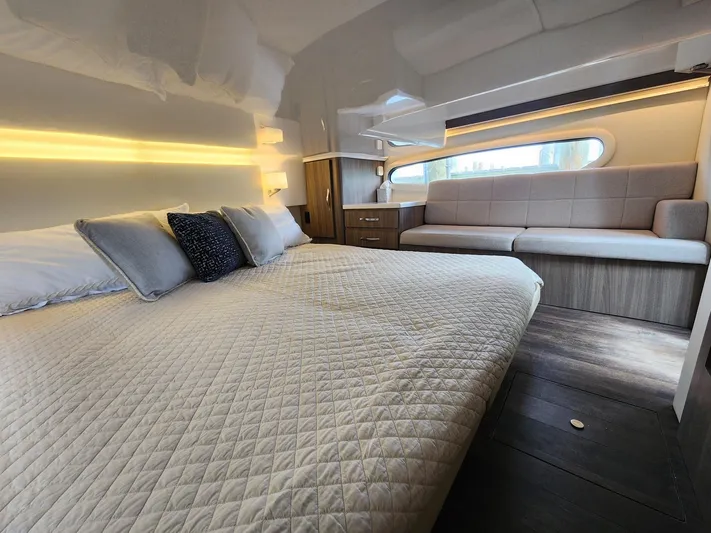 Dilligaf Yacht Photos Pics Luxurious interior of 2020 Regal 38 XO yacht with cozy bed and seating area.