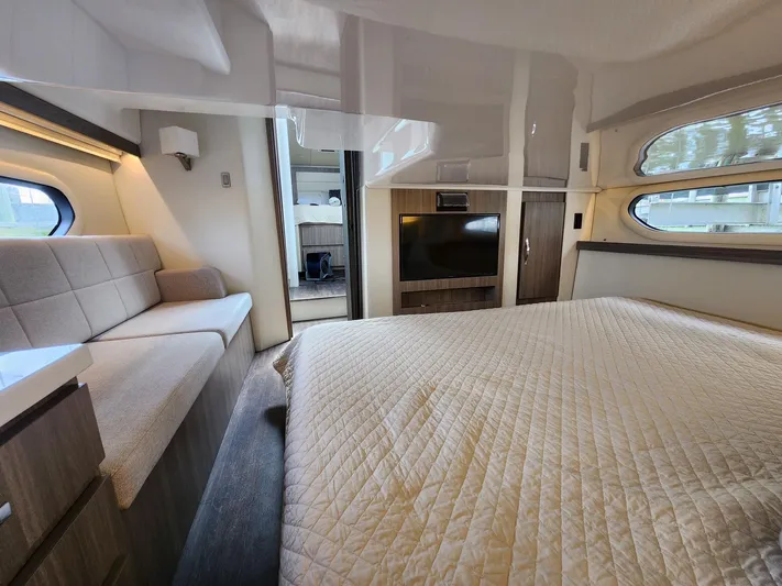 Dilligaf Yacht Photos Pics Luxurious interior of a 2020 Regal 38 XO yacht with cozy bed and modern decor.