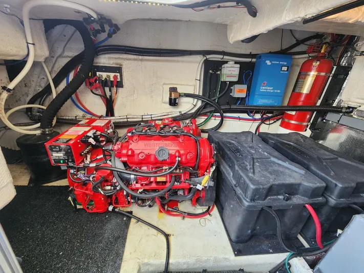 Dilligaf Yacht Photos Pics Engine room of a 2020 Regal 38 XO boat, featuring a red engine and electrical components.