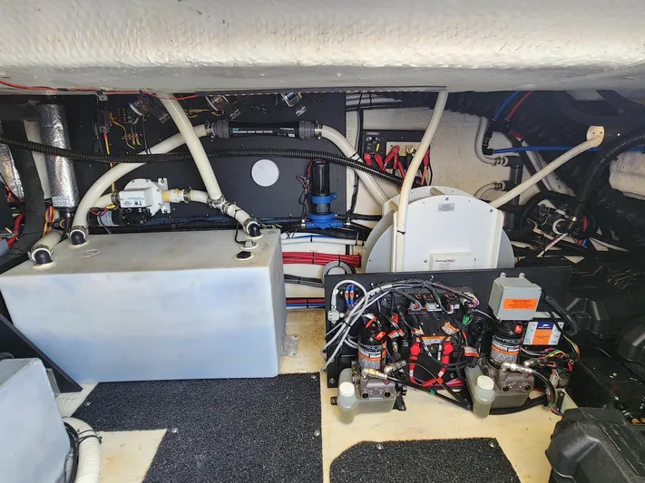 Dilligaf Yacht Photos Pics Engine room of a 2020 Regal 38 XO boat, showcasing mechanical components and wiring.