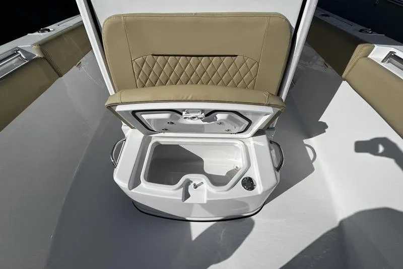  Yacht Photos Pics 2026 Sportsman Open 252 Center Console boat with open storage compartment and cushioned seating.