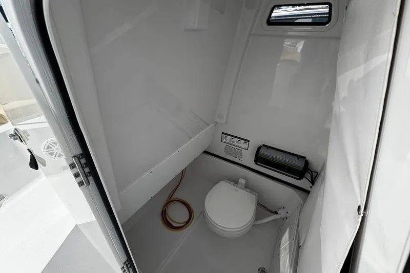  Yacht Photos Pics 2026 Sportsman Open 252 Center Console boat interior with compact marine toilet.