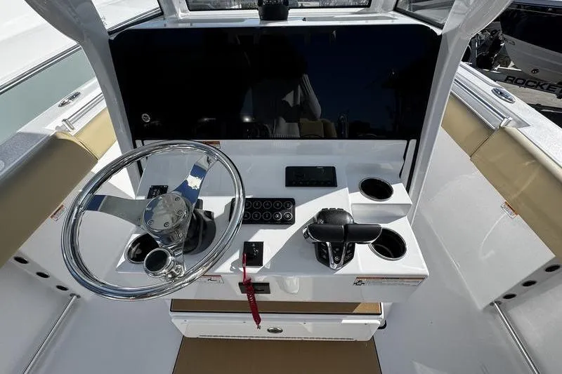  Yacht Photos Pics 2026 Sportsman Open 252 Center Console helm with steering wheel and controls.