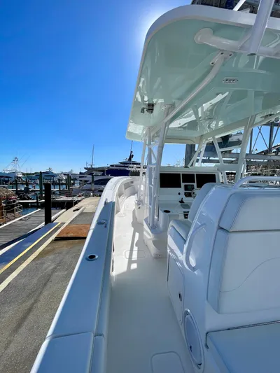 Deeper Yacht Photos Pics 2022 Invincible 39' Open Fisherman boat docked under clear blue sky.