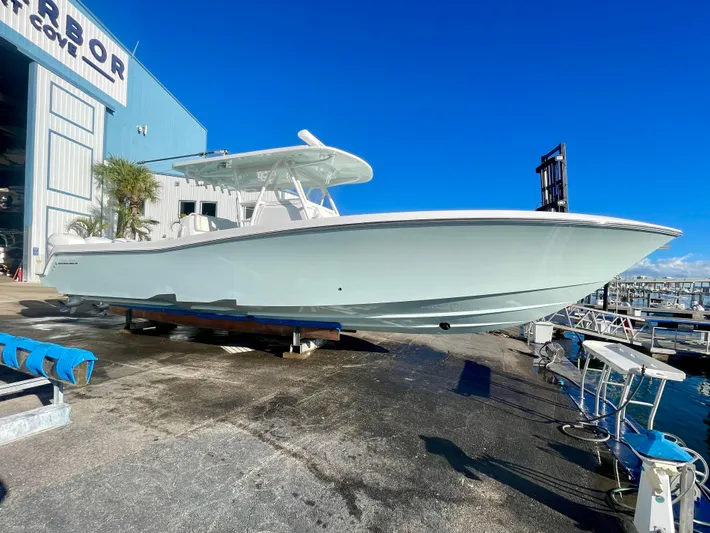 Deeper Yacht Photos Pics 2022 Invincible 39' Open Fisherman boat on dock under clear blue sky.