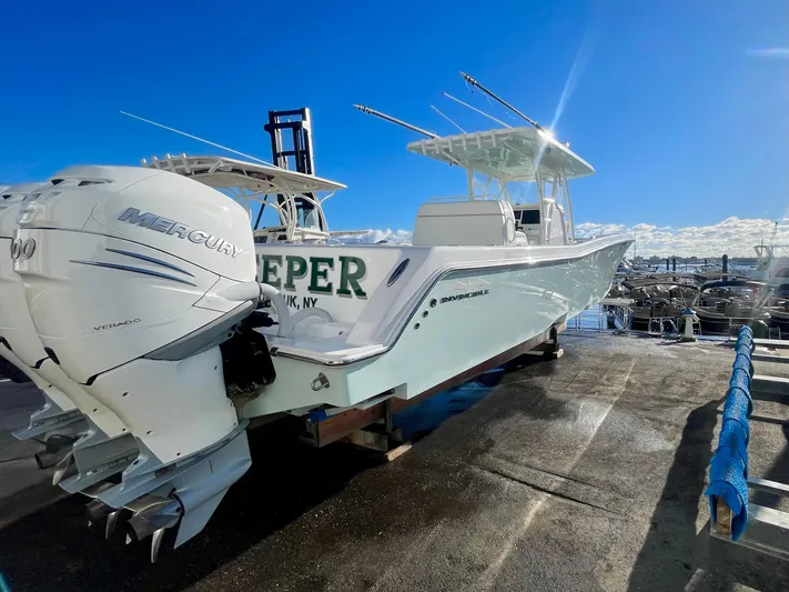 Deeper Yacht Photos Pics 2022 Invincible 39' Open Fisherman boat with Mercury engines, docked under clear blue sky.